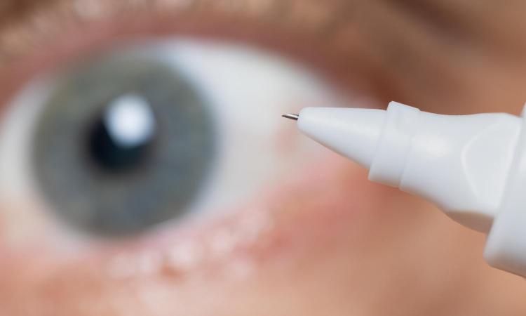 A closeup of a microneedle in front of an eye