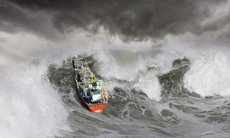 A ship tossed by rough seas and large waves. (Photo: John Lund, Getty Images)