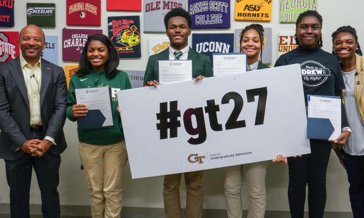 Raheem Beyah with 4 Drew Charter School students and staff member from GT admissions, holding #gt27 sign