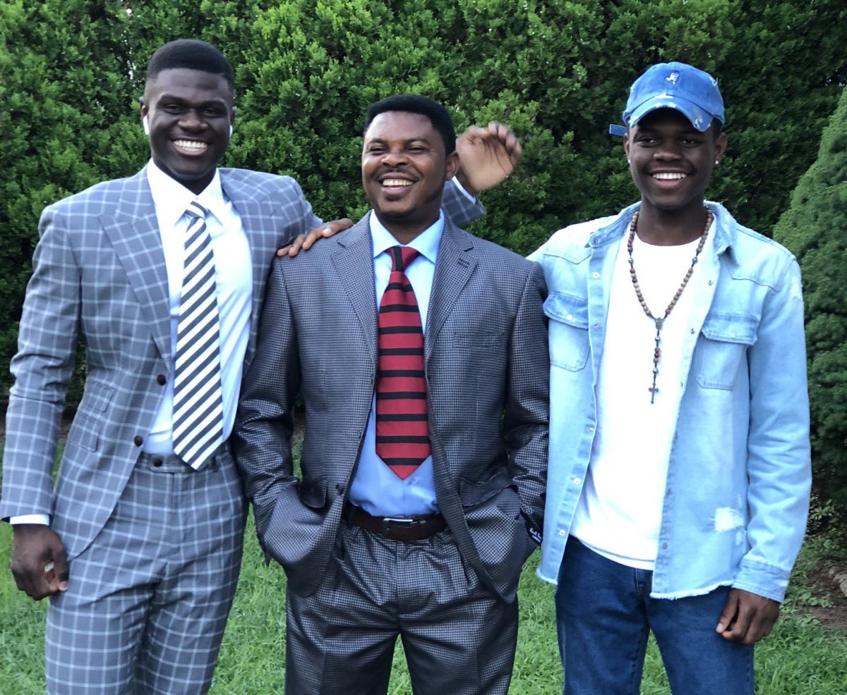 Gideon Ndeh with his father and brother