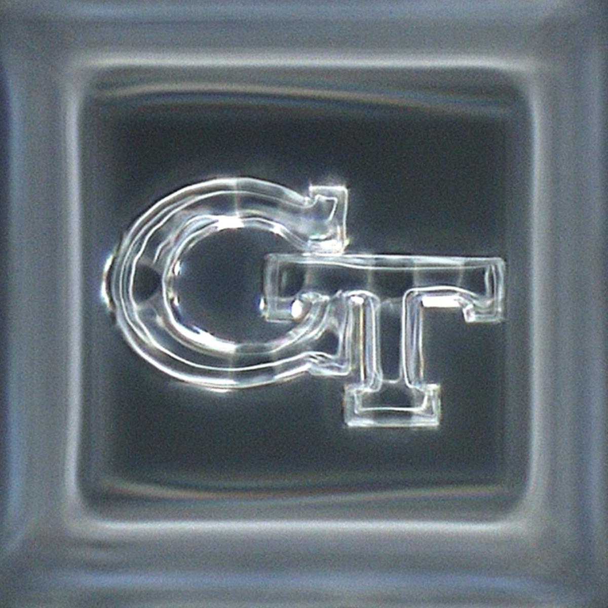a 3D printed silica glass interlocking GT logo