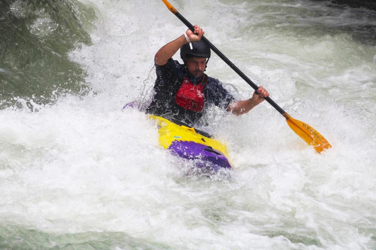 Thomas Vandiver kayaks through whitewater