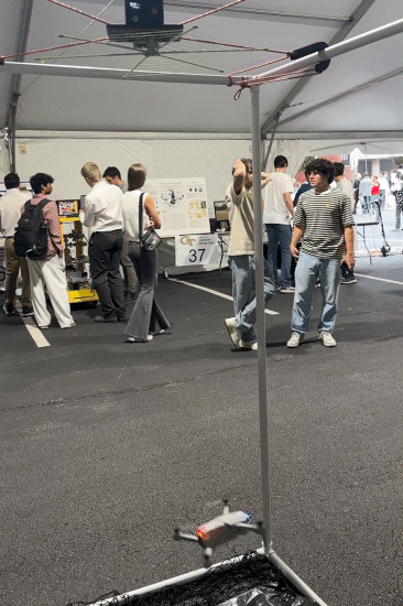 A spiderweb-like net drops onto a drone and causes it to crash.