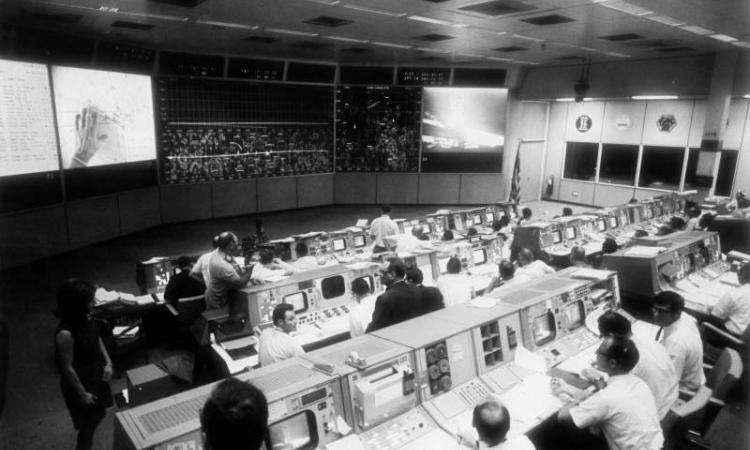 historic black and white photo of NASA mission control during the Apollo program