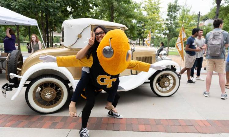 student sitting on Buzz's back