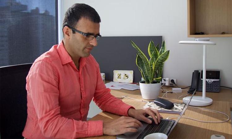 Saman Zonouz works on a laptop