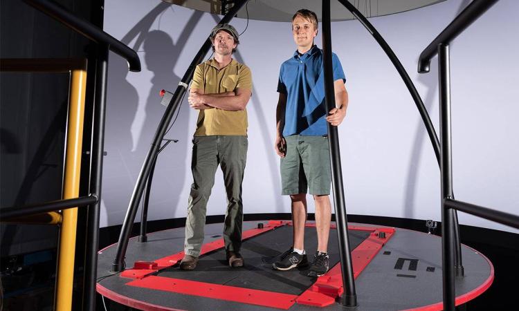 Two people standing on a treadmill platform