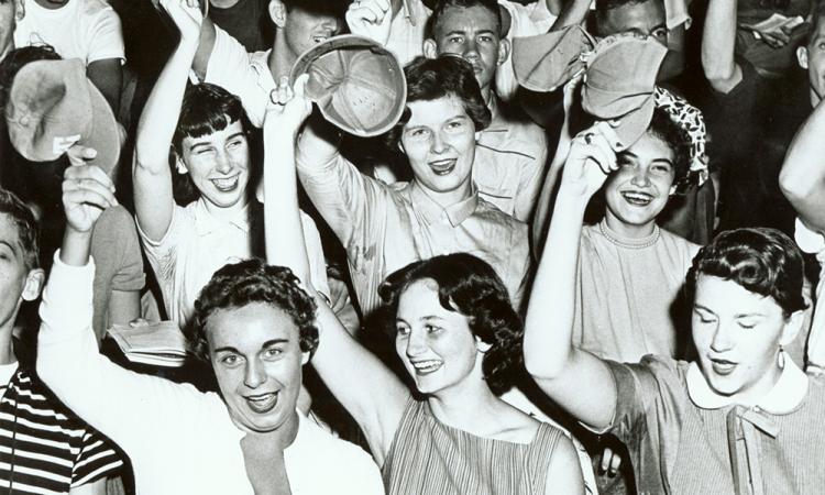a historic photo of women students with RAT caps