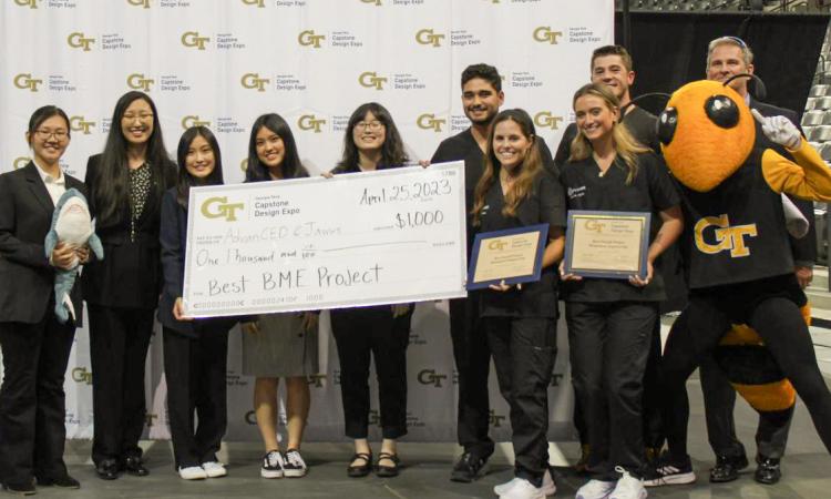The two winning BME teams with Buzz and a winner's check