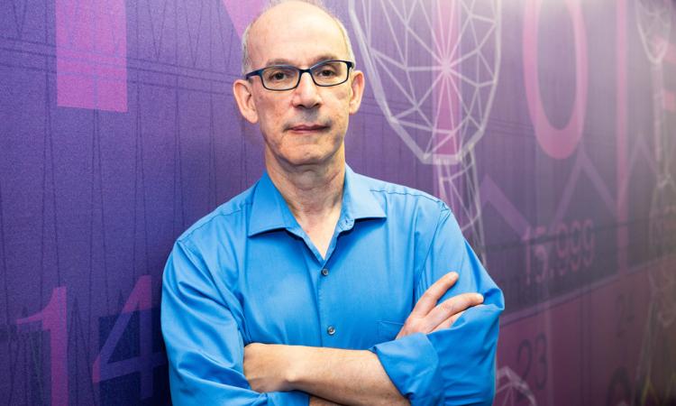 M.G. Finn stands next to a purple wall. (Photo: Joya Chapman)