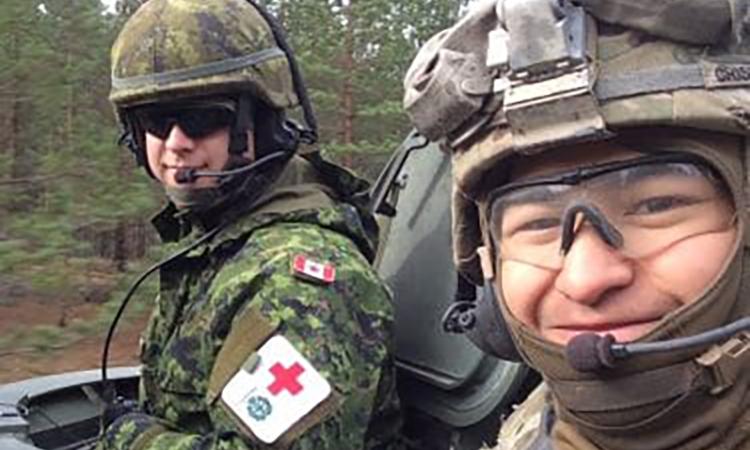 Corey Crisostomo (right) during his time as a medic in the United States Army.