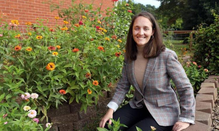 Marta Hatzell with plants in a campus garden.