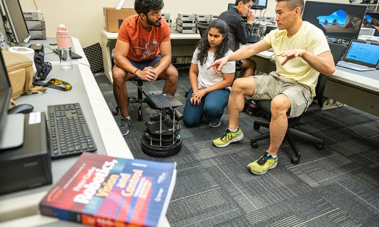 students working with a robot