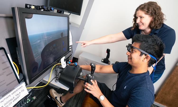 Karen Feigh and a student look at a simulator on a computer screen