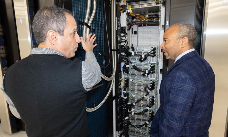 Dean Raheem Beyah looks at computer servers in the AI Makerspace