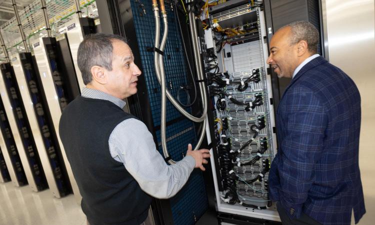 Ruben Lara and Dean Beyah look at a server cabinet in the AI Makerspace