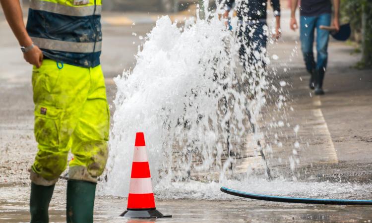 water coming from street after pipe burst