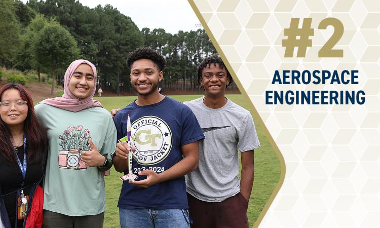 a group of students holding a model rocket with the text "#2 Aerospace Engineering"