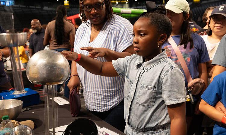 student touching globe at stem fest 2024 event