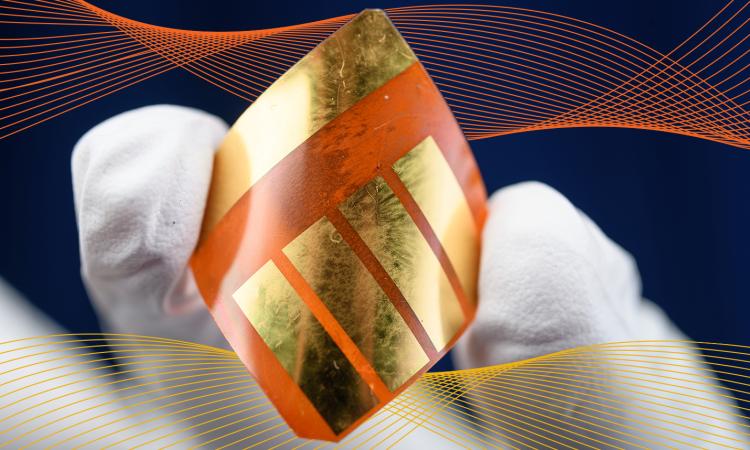 a gloved hand holding a solar cell with an overlay of decorative vector lines