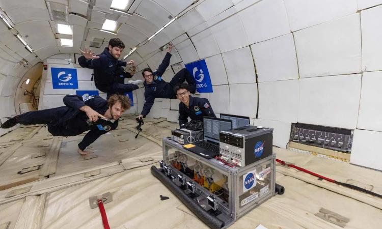 Four researchers float above an experimental rig during a microgravity parabolic flight. The team performed multiple CubeSat experiments aboard Zero Gravity Corp.'s modified 727 aircraft. Photo: Steve Boxall