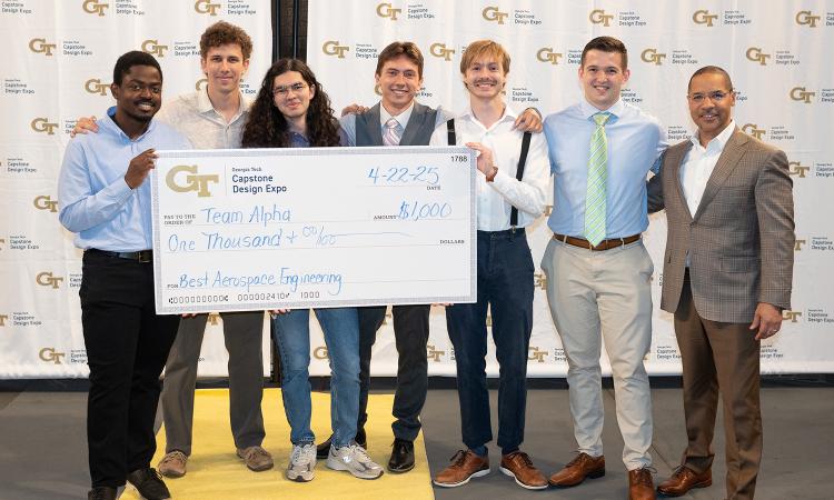 a group of people with an oversized check