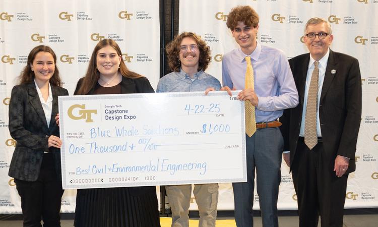 a group of people with an oversized check