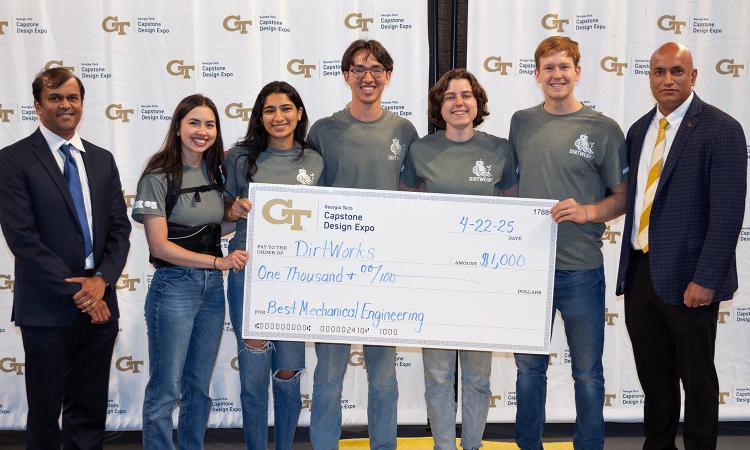 a group of people with an oversized check