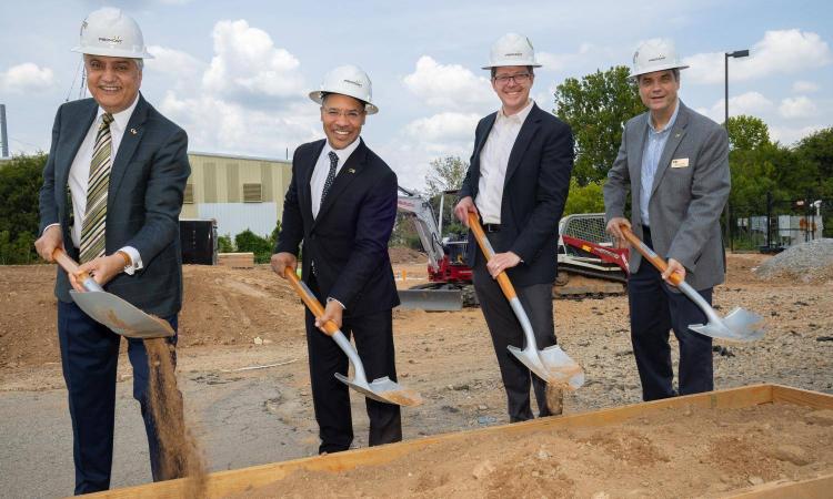 Four people with shovels at a groundbreaking