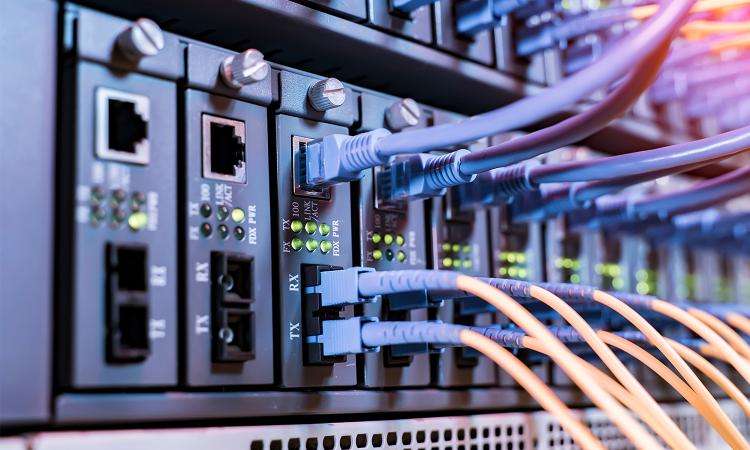 stock image of many wires and cables plugged into a computer network