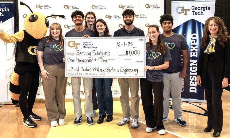 a group of students with Buzz and an oversized winners check