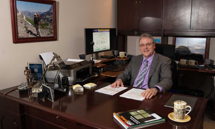 McDowell sits at his desk