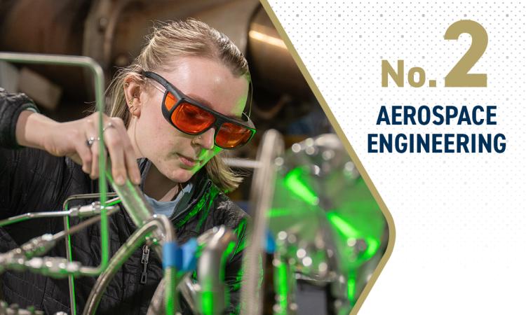 a person in safety goggles works in an aerospace lab