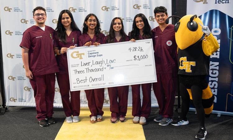 a group of people in scrubs pose with an oversized check and Buzz