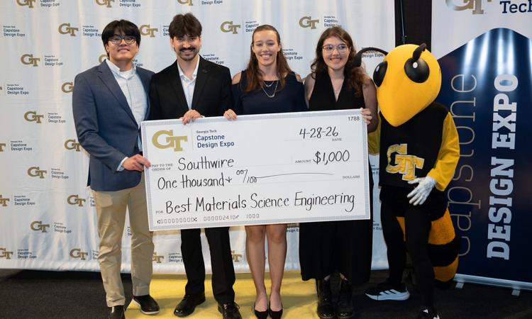 a group of people with an oversized check and Buzz