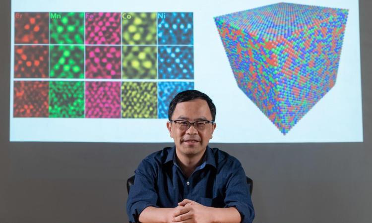 ME Professor Ting Zhu in front of images of polycrystalline metals