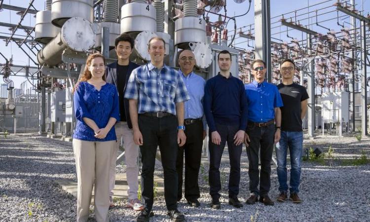 The TESLA team in front of high-voltage circuit breakers
