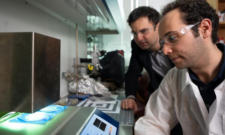 Fatih Sarioglu and Mert Boya fabricate a microchip in the lab