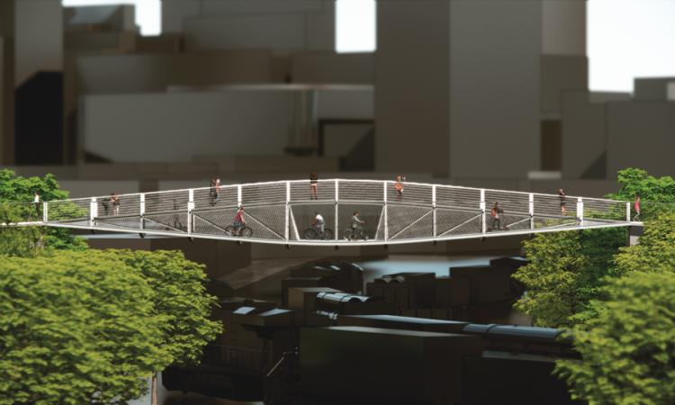 Rendering of the winning bridge design over shadowed railroad tracks and nondescript buildings in the background. The bridge has two levels, giving it a split profile that resembles an eye.