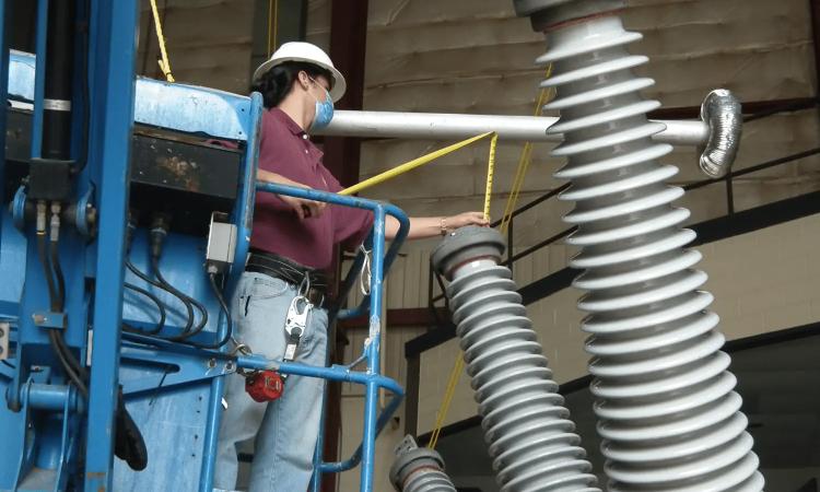 A NEETRAC technician evaluating a high voltage circuit breaker.