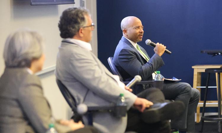 Dean Raheem Beyah speaks on a dean's panel at the 2023 NextProf Nexus while Michigan Engineering Interim Dean Steven Ceccio and Cal Engineering Dean Tsu-Jae King Liu listen.