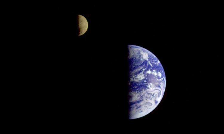 A photo of the Earth and moon, both half in shadow, taken by the Galileo spacecraft. (Photo Courtesy: NASA)