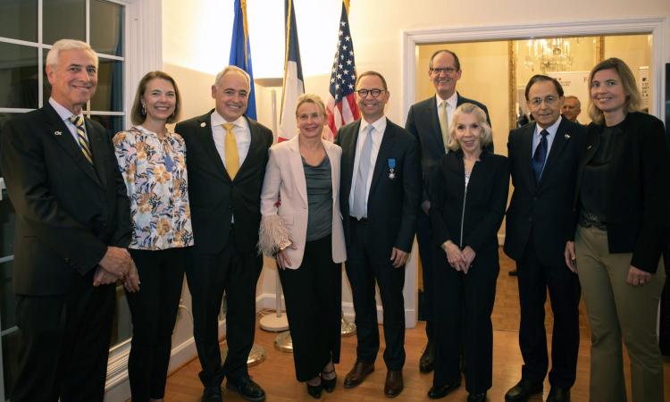 Bernard Kippelen receiving the Knight of the French National Order of Merit at the Residence of France in Atlanta. Pictured left to right are Yves Berthelot, Beth Cabrera, Ángel Cabrera, Virginie Kippelen, Bernard Kippelen, Steve McLaughlin, Marta H. Garcia, John McIntyre, and Anne-Laure Desjonquères.