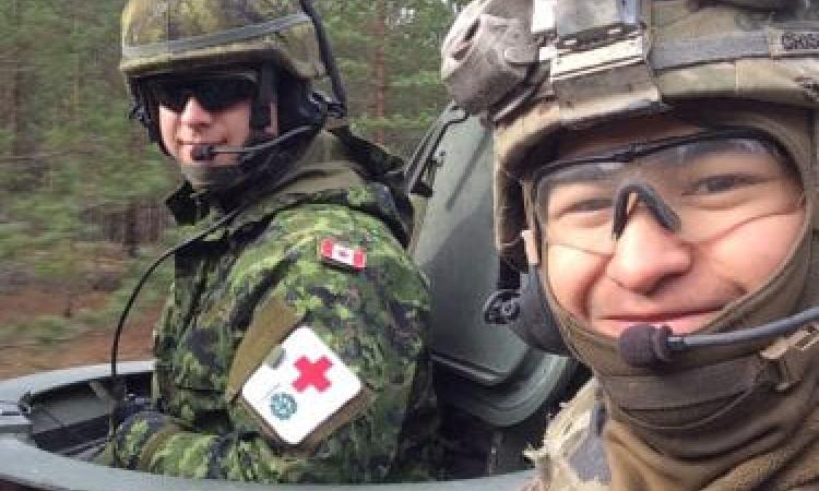 Corey Crisostomo (right) during his time as a medic in the United States Army.