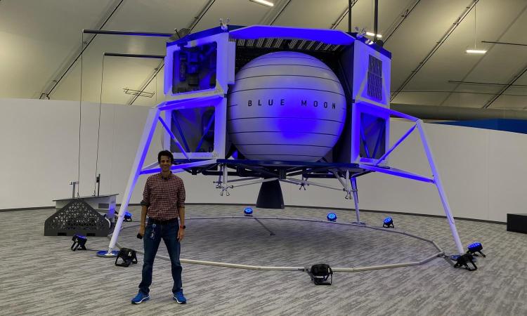 Fred Willeneuve stands in front of a model of Blue Origin's moon lander.