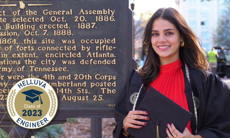 Nicole Proudfoot stands by the Georgia Tech historical marker with a "Helluva Engineer - Class of 2023" graphical overlay