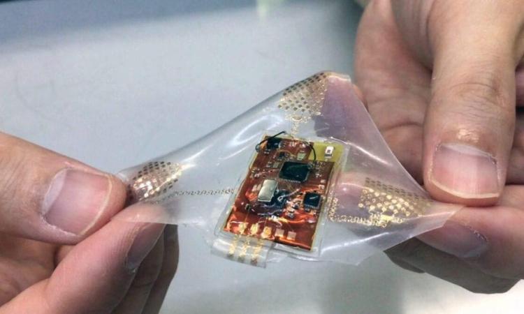 Two hands holding a prototype flexible health monitor created by Georgia Tech researchers.