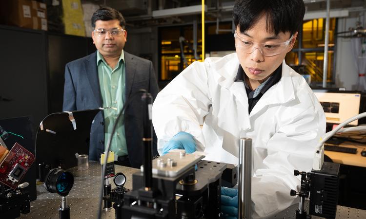 Assistant professor Sourabh Saha and Ph.D. student Jungho Choi work with a light projection system