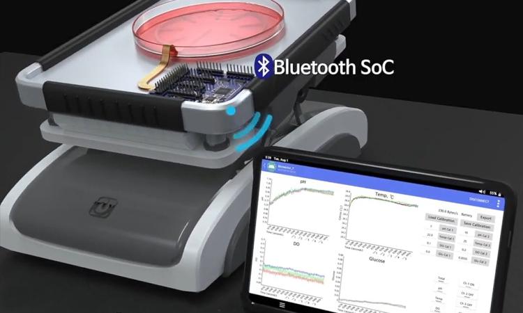 a rendering of a stem cell culture with a monitoring sensor and the results on a screen in the foreground