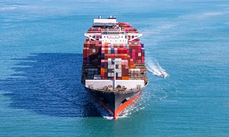 stock image of a cargo ship loaded with shipping containers